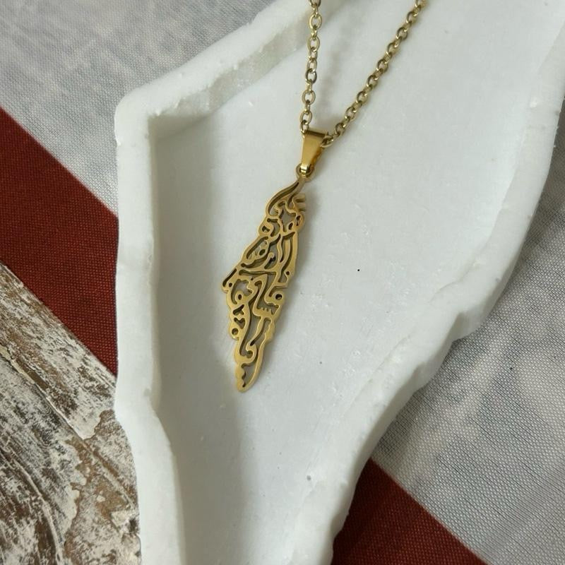Palestine Map Necklace Engraved with Mahmoud Darwish’s iconic words: “على هذه الأرض ما يستحق الحياة” On this land, there is what deserves life
